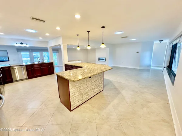 a large kitchen with stainless steel appliances granite countertop a stove sink and cabinets