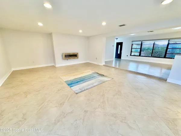 a view of an empty room with windows