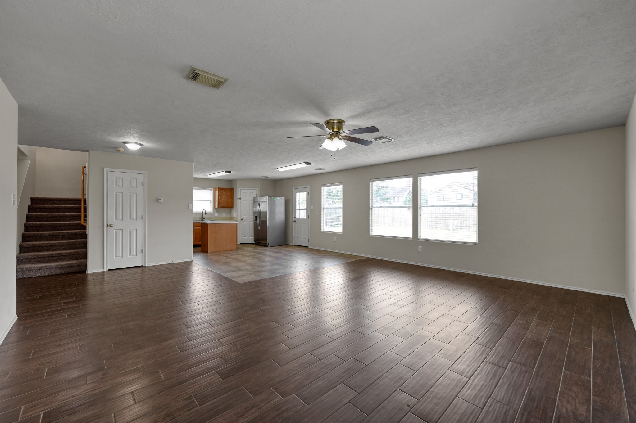 23919 Kingbriar Drive Spring, TX 77373 - Photo 13 of 33 Large windows fill the living room with natural light, creating a bright and inviting atmosphere.