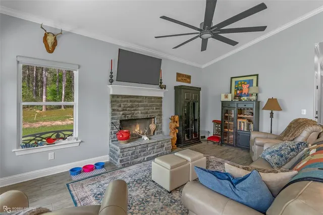 a living room with furniture fireplace and a window
