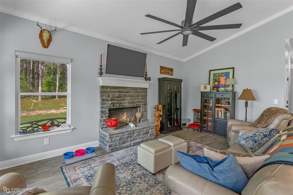 260 Circle M Road Benton, LA 71006 - Photo 16 of 35 a living room with furniture fireplace and a window