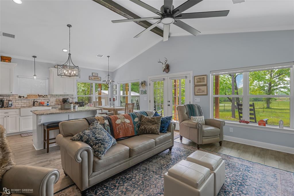260 Circle M Road Benton, LA 71006 - Photo 17 of 35 a living room with furniture and a large window with kitchen view