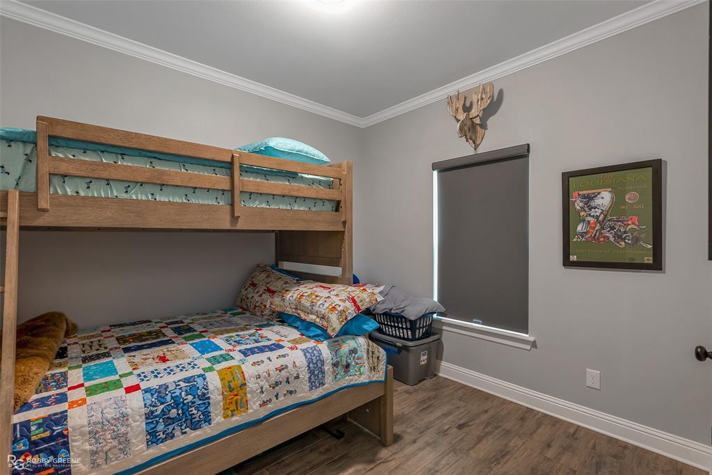 260 Circle M Road Benton, LA 71006 - Photo 20 of 30 a bedroom with bed and wooden floor