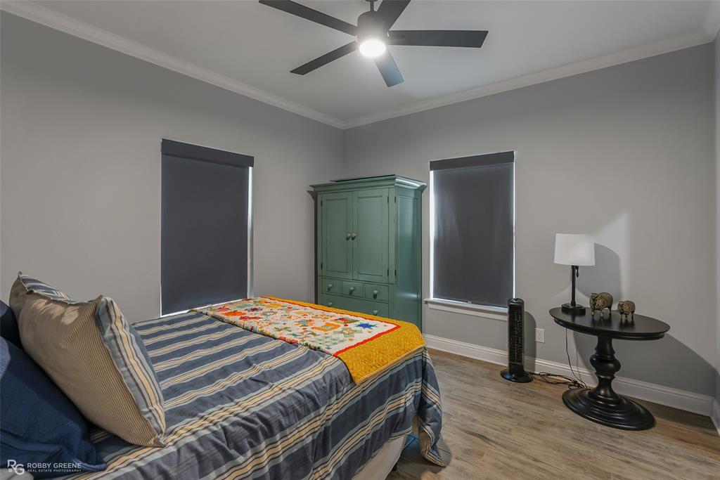 260 Circle M Road Benton, LA 71006 - Photo 21 of 35 a bedroom with a bed and a chandelier