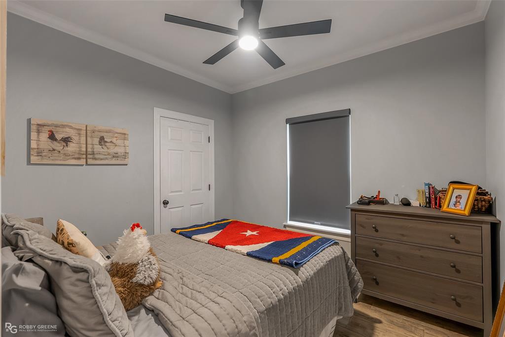 260 Circle M Road Benton, LA 71006 - Photo 22 of 30 a bedroom with a bed and a chandelier