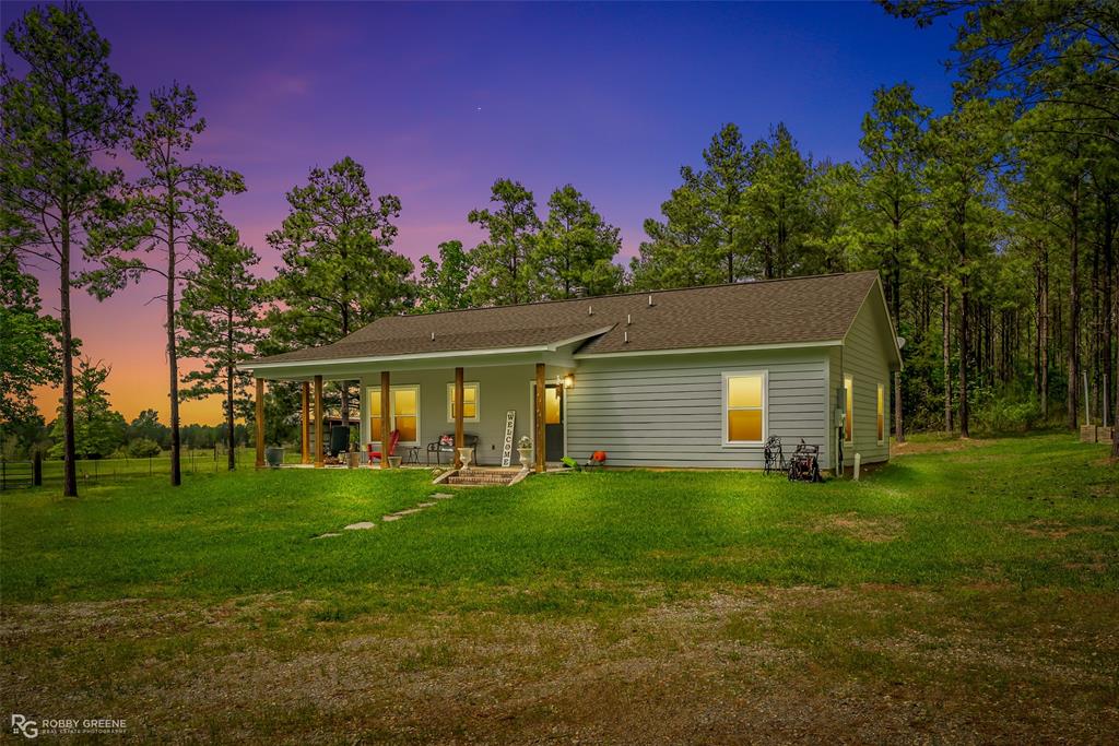 260 Circle M Road Benton, LA 71006 - Photo 5 of 35 a backyard of a house with table and chairs