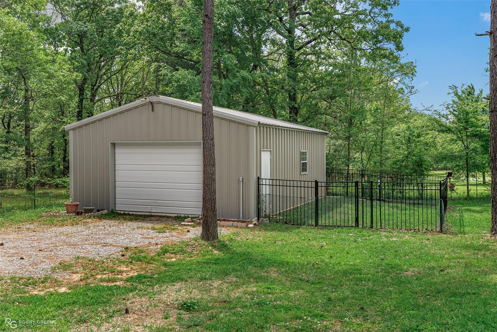 260 Circle M Road Benton, LA 71006 - Photo 8 of 35 a house with green field in front of it