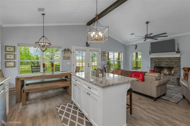 a living room with fireplace furniture and a chandelier