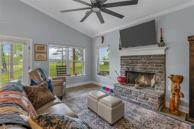a living room with furniture a flat screen tv and a fireplace