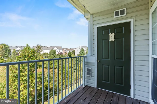 a view of balcony with wooden floor and fence