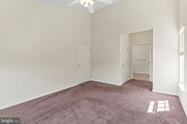 a bathroom with a granite countertop toilet sink and mirror