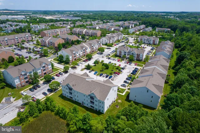an aerial view of multiple houses with yard