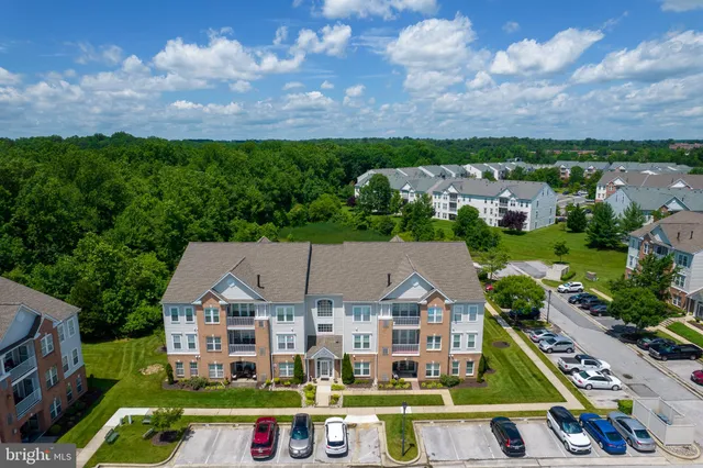 an aerial view of multiple houses with a big yard