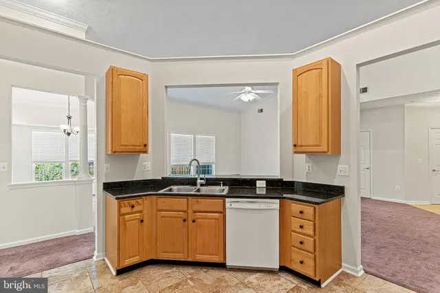 a kitchen with granite countertop a sink and a stove