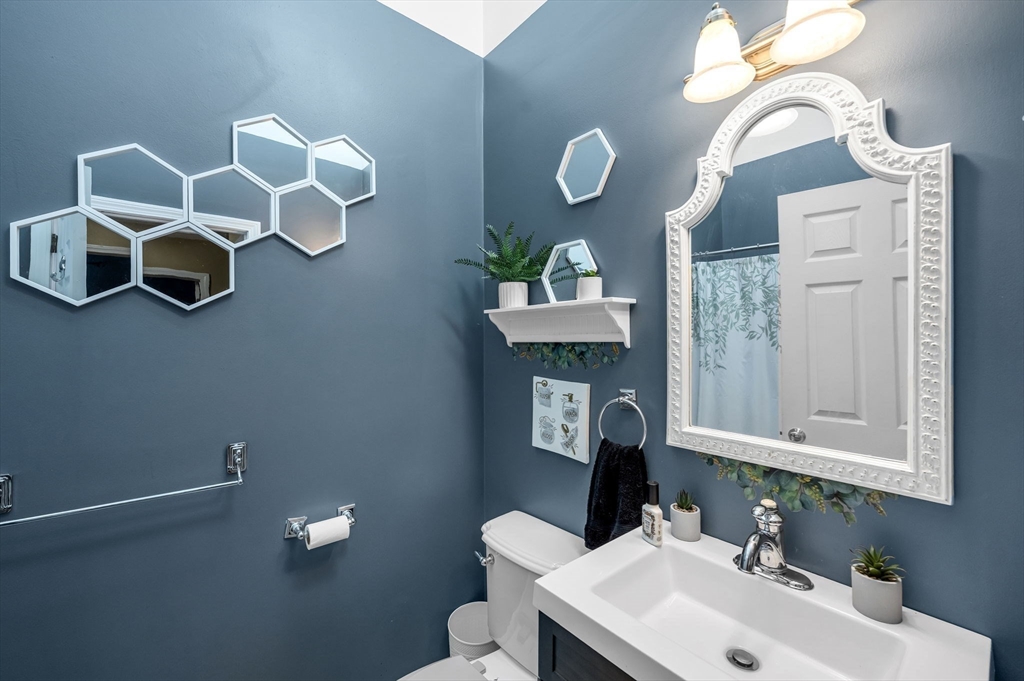 77 Gates Avenue Springfield, MA 01118 - Photo 21 of 42 a bathroom with a sink mirror and vanity