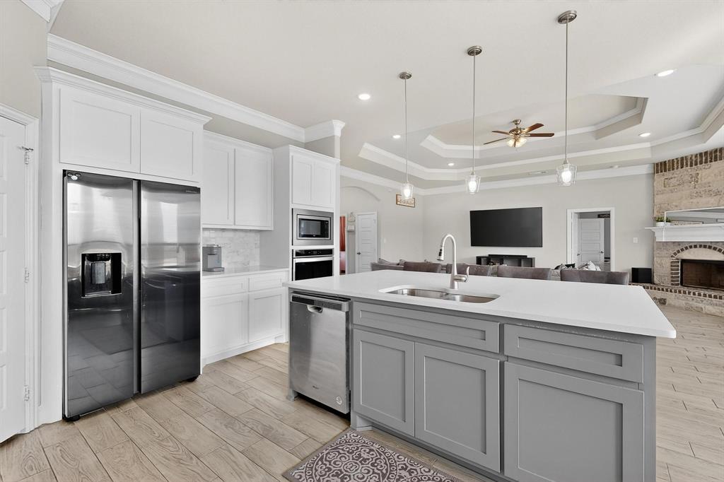 129 Altom Road Springtown, TX 76082 - Photo 11 of 40 a kitchen with kitchen island sink and refrigerator