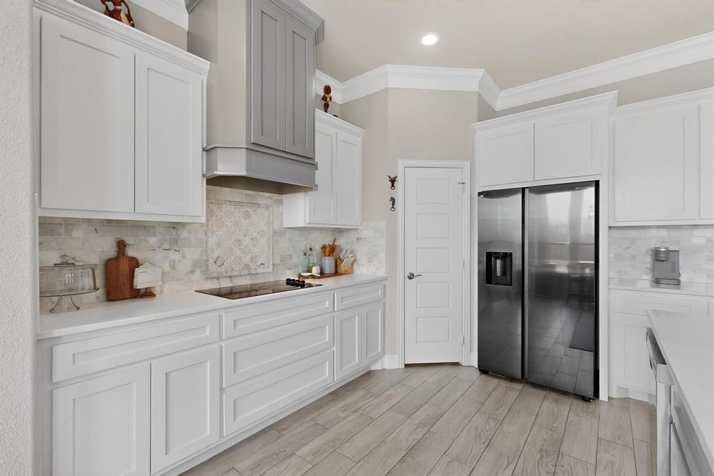 129 Altom Road Springtown, TX 76082 - Photo 12 of 40 a kitchen with stainless steel appliances granite countertop a refrigerator sink and white cabinets