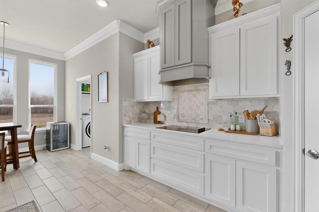 129 Altom Road Springtown, TX 76082 - Photo 13 of 40 a kitchen with granite countertop white cabinets and chairs