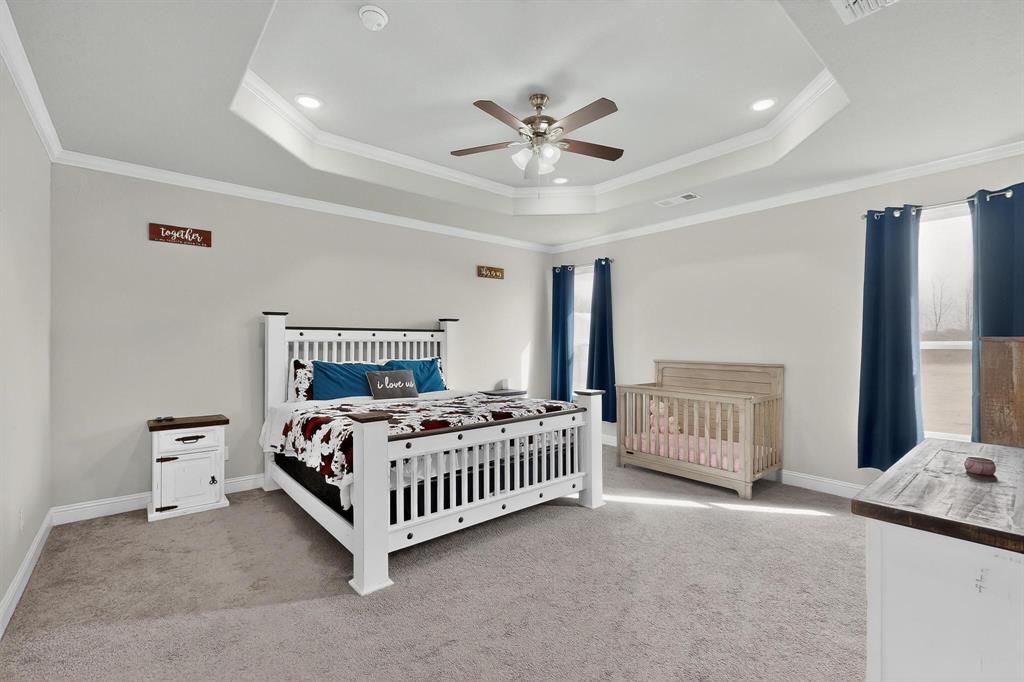 129 Altom Road Springtown, TX 76082 - Photo 15 of 40 a bedroom with a bed window and a bed