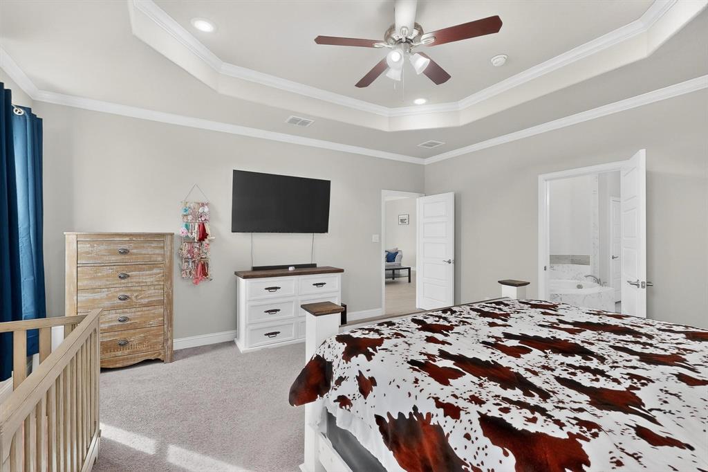 129 Altom Road Springtown, TX 76082 - Photo 17 of 40 a bedroom with a bed and a flat screen tv