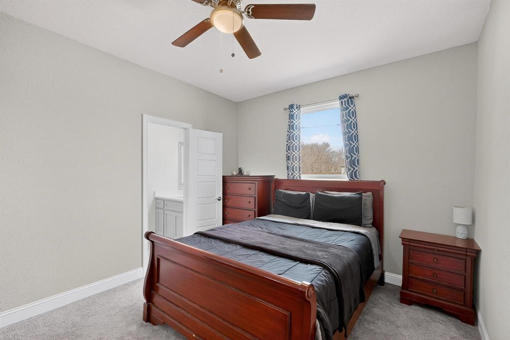 129 Altom Road Springtown, TX 76082 - Photo 27 of 40 a bedroom with a bed and cabinet