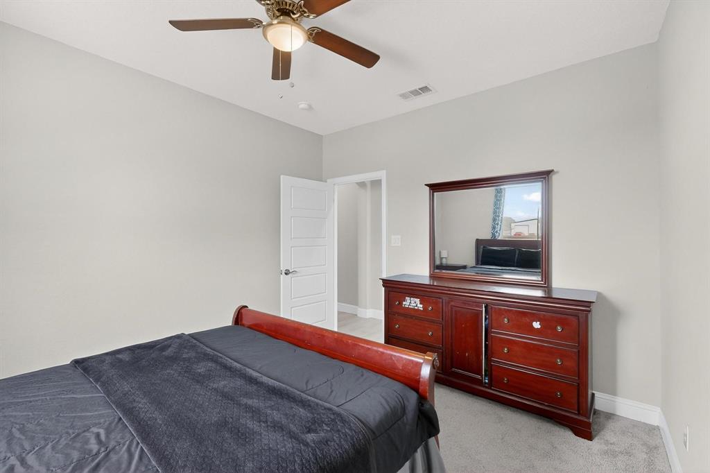 129 Altom Road Springtown, TX 76082 - Photo 28 of 40 a bedroom with a bed and a dresser in it