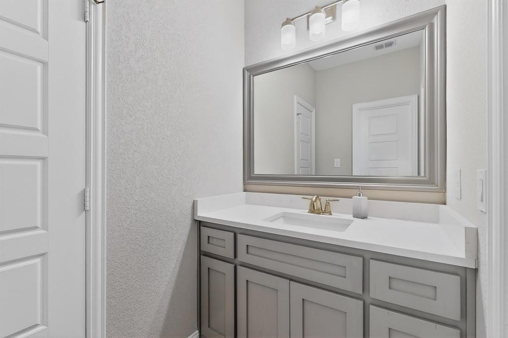 129 Altom Road Springtown, TX 76082 - Photo 29 of 40 a bathroom with a sink and a mirror