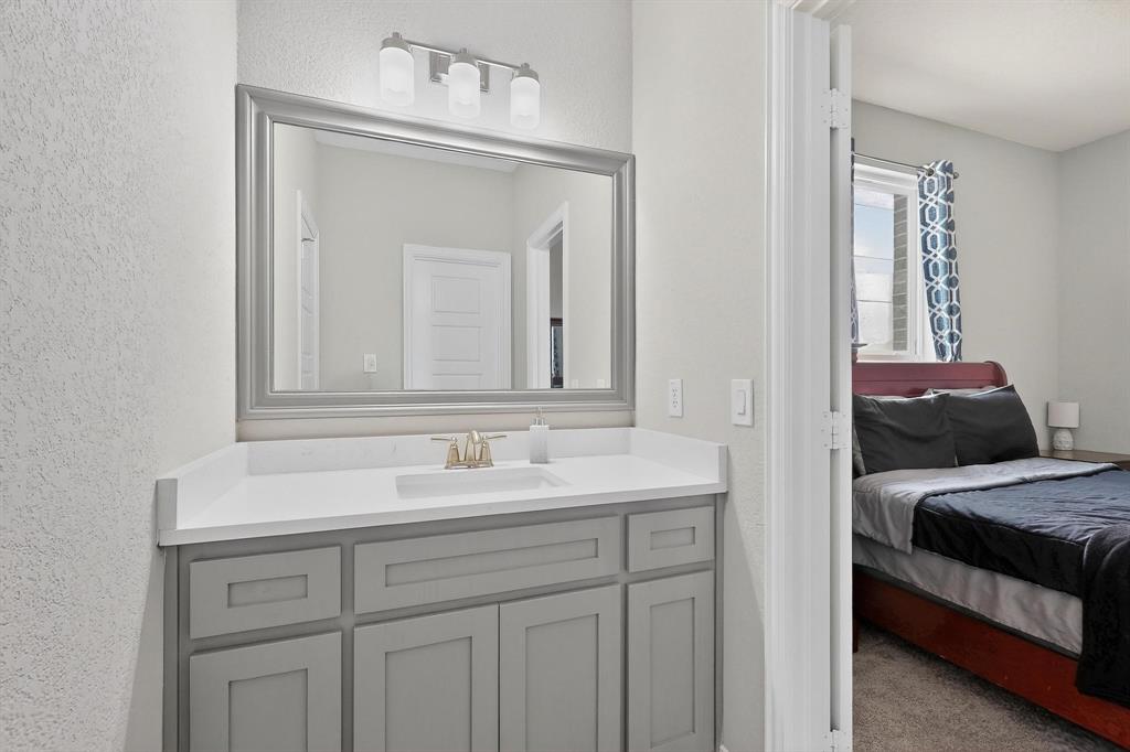 129 Altom Road Springtown, TX 76082 - Photo 30 of 40 a en suite bathroom with a sink and a mirror