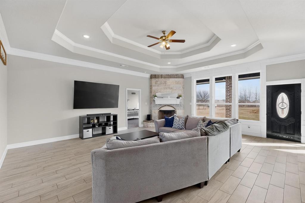 129 Altom Road Springtown, TX 76082 - Photo 6 of 40 a living room with furniture and a flat screen tv