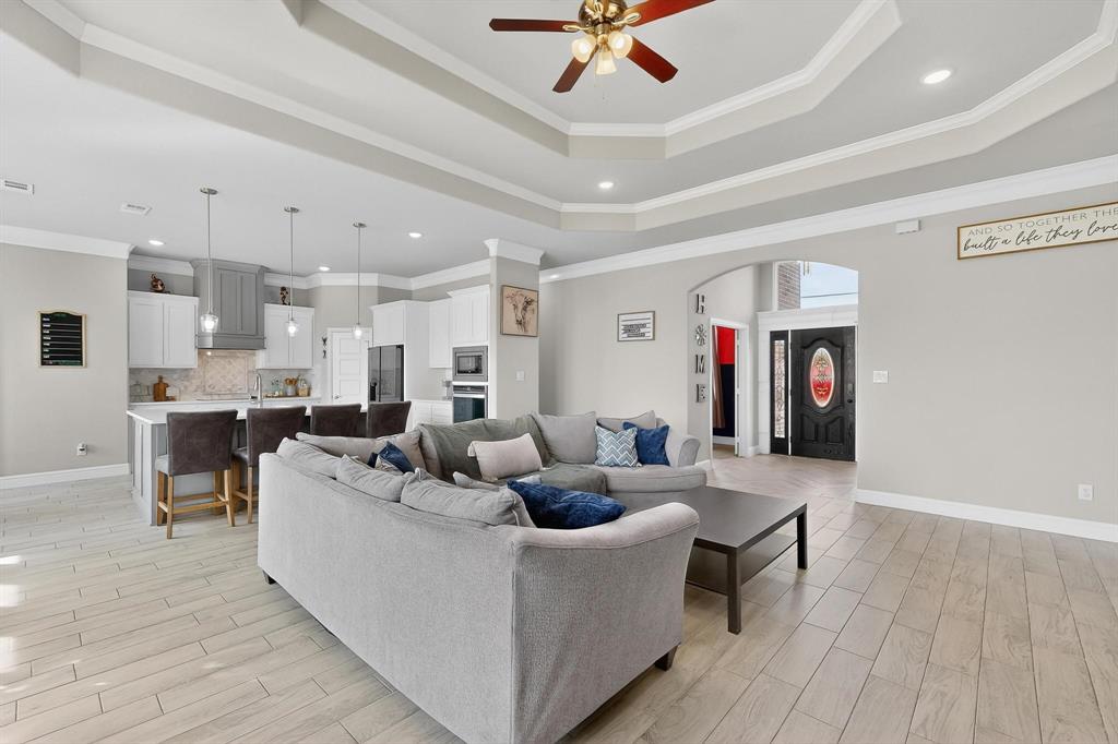 129 Altom Road Springtown, TX 76082 - Photo 8 of 40 a living room with furniture and a wooden floor