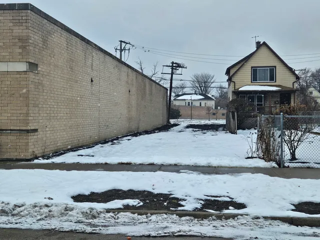 a view of a house with snow on the road
