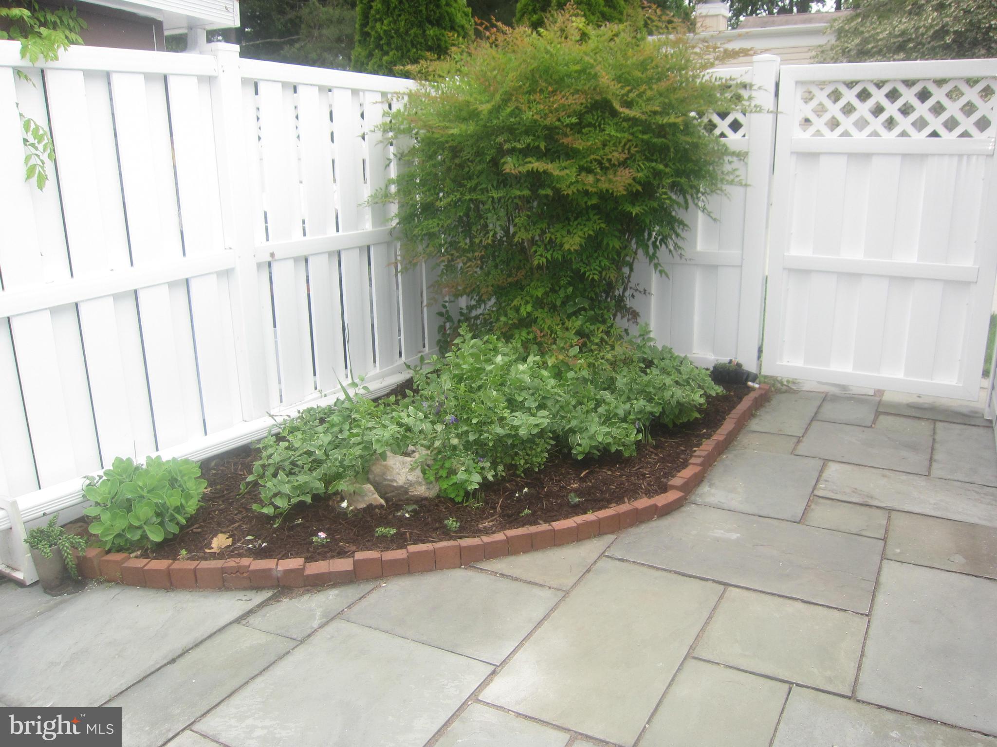 3606 Edelmar Terrace, Unit 128A Silver Spring, MD 20906 - Photo 26 of 30 Backyard garden, slate patio