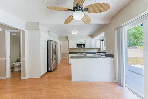 a view of empty room with wooden floor and fireplace