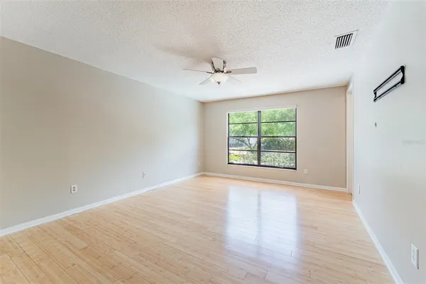 a view of an empty room with a ceiling fan