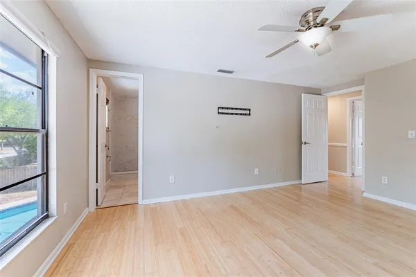 wooden floor in an empty room with a window