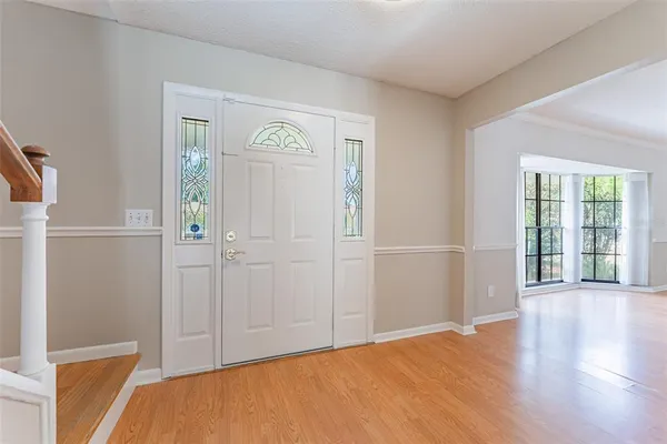 a kitchen with stainless steel appliances white cabinets a sink dishwasher a stove and a microwave oven with granite countertops