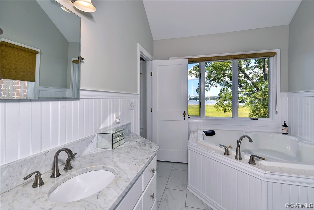 528 10th Street West Point, VA 23181 - Photo 20 of 50 a bathroom with a granite countertop sink and a large mirror