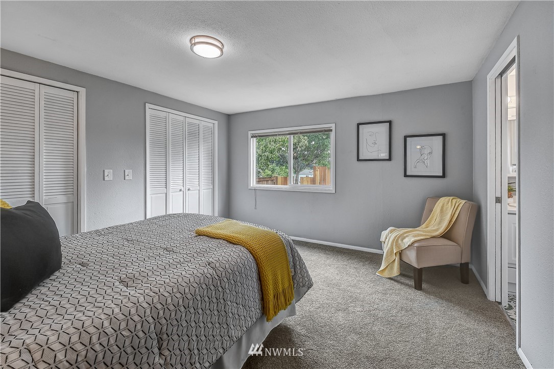 12723 Northeast 199th Street Bothell, WA 98011 - Photo 18 of 34 a bedroom with a bed and a chair