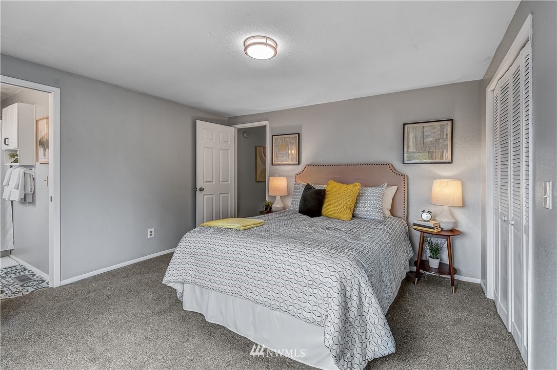 12723 Northeast 199th Street Bothell, WA 98011 - Photo 20 of 34 a bedroom with a bed and lamps