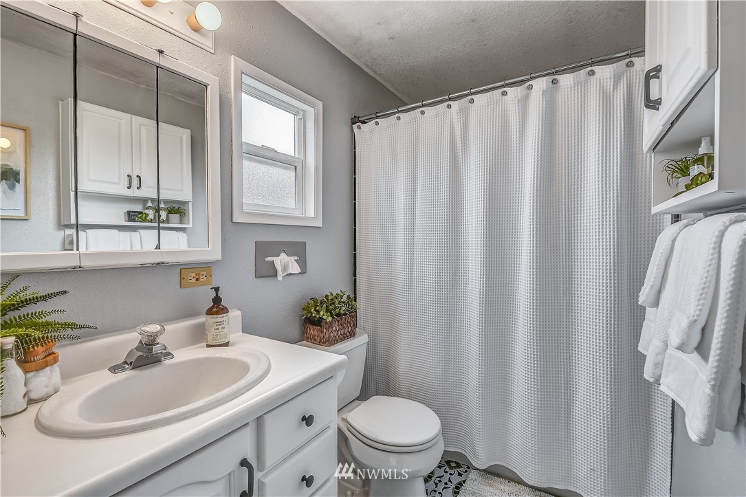12723 Northeast 199th Street Bothell, WA 98011 - Photo 21 of 34 a bathroom with a sink toilet and mirror