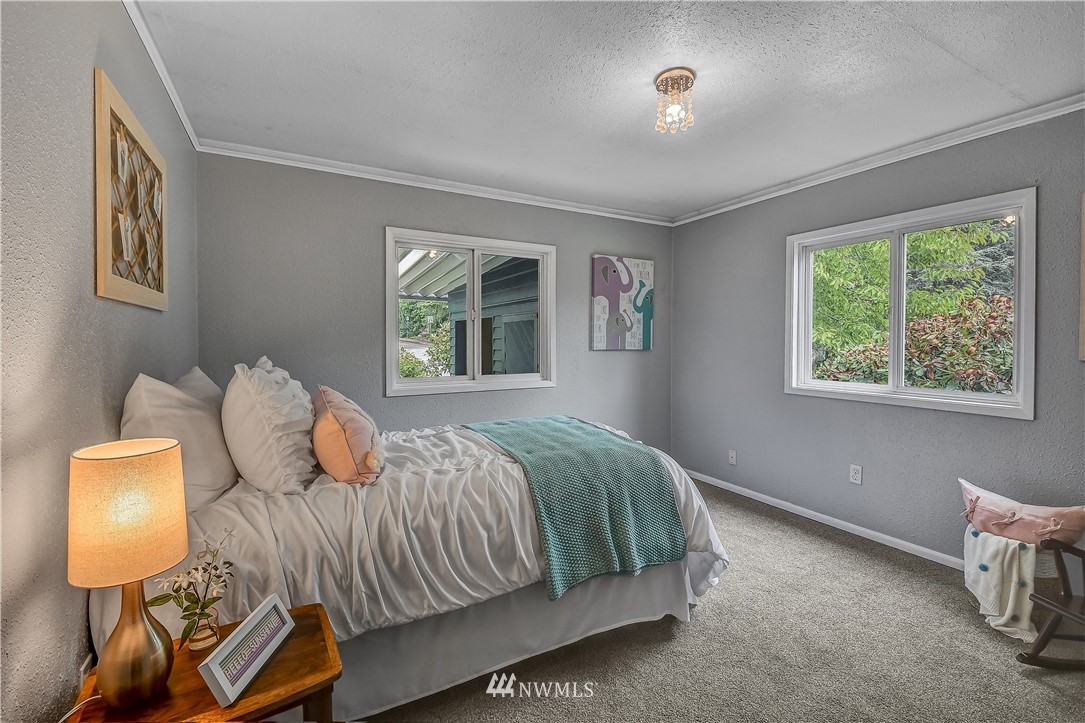 12723 Northeast 199th Street Bothell, WA 98011 - Photo 22 of 34 a bedroom with a bed and window