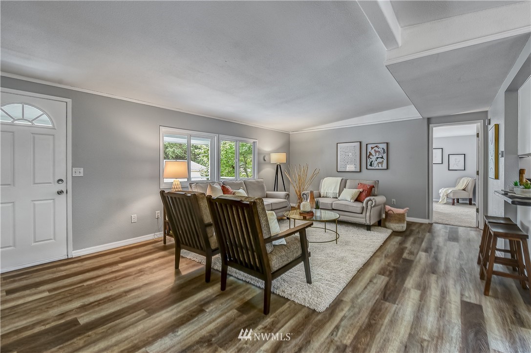 12723 Northeast 199th Street Bothell, WA 98011 - Photo 6 of 34 a living room with furniture and a wooden floor