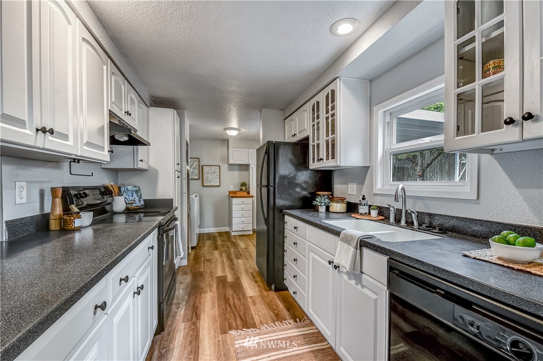 12723 Northeast 199th Street Bothell, WA 98011 - Photo 10 of 34 a kitchen with stainless steel appliances granite countertop a stove a sink dishwasher and a refrigerator