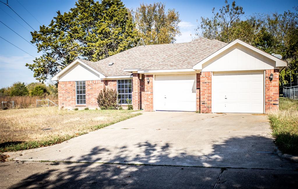 a view of a house with a yard and garage