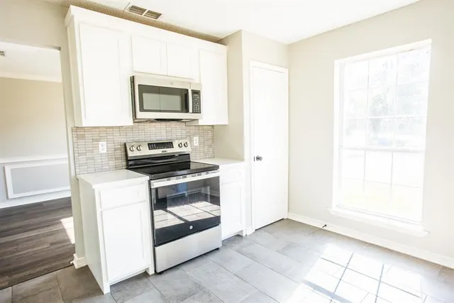 a kitchen with a stove and a microwave