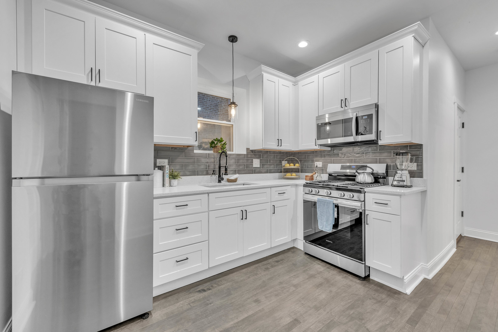 4844 West 23rd Street Cicero, IL 60804 - Photo 8 of 36 a kitchen with white cabinets stainless steel appliances and a sink