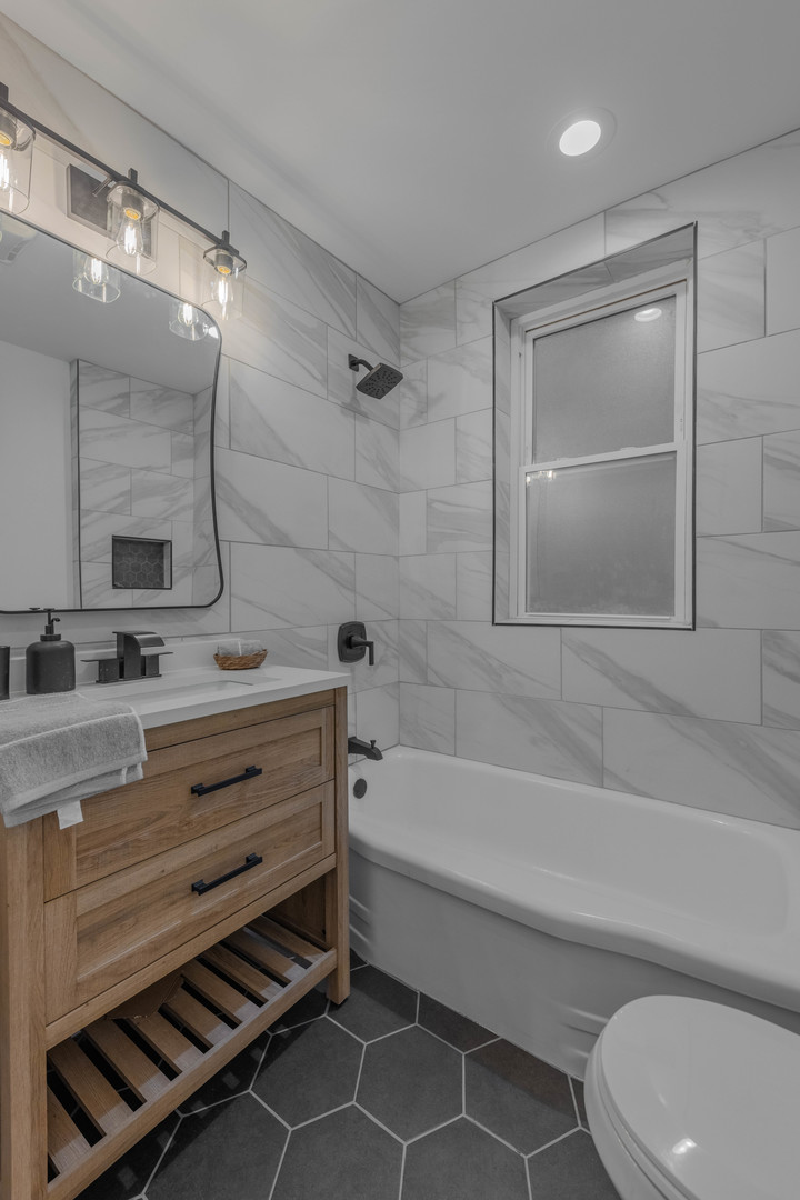 4844 West 23rd Street Cicero, IL 60804 - Photo 10 of 36 a bathroom with a sink a toilet and bathtub