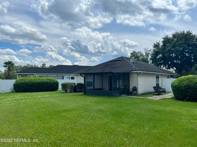 a view of a house with a yard and a garden