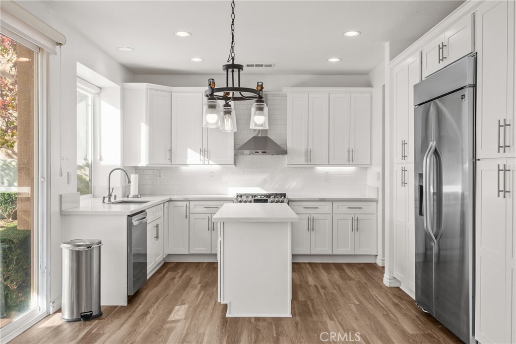 9749 Orange Street Rancho Cucamonga, CA 91737 - Photo 11 of 38 a kitchen with stainless steel appliances granite countertop a sink stove and refrigerator