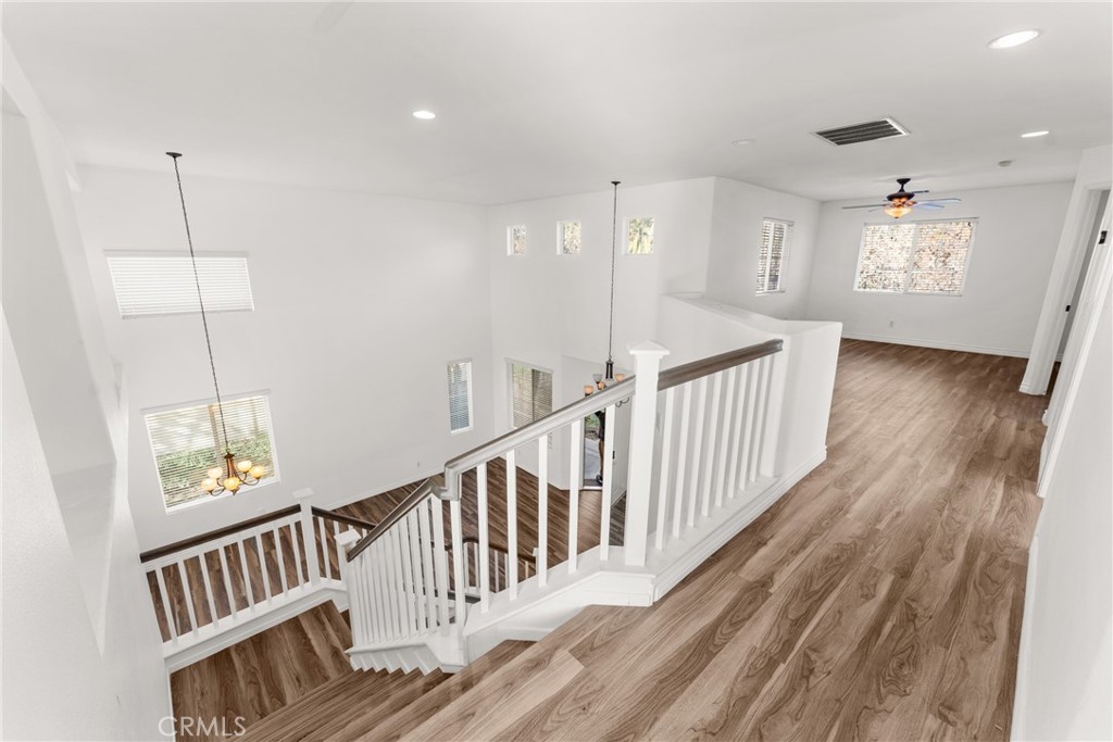 9749 Orange Street Rancho Cucamonga, CA 91737 - Photo 18 of 38 a view of staircase with wooden floor and windows